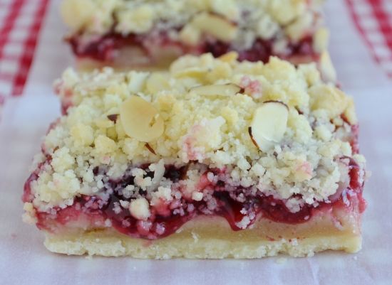 two pieces of cake sitting on top of a red and white checkered table cloth