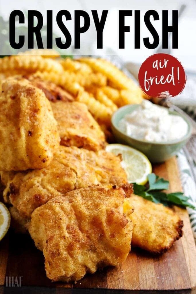 crispy fish served on a cutting board with lemon wedges