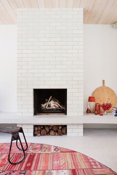 a living room with a fire place and rug