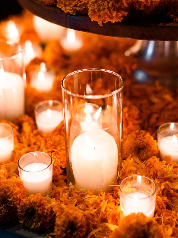 candles and flowers are arranged on the ground