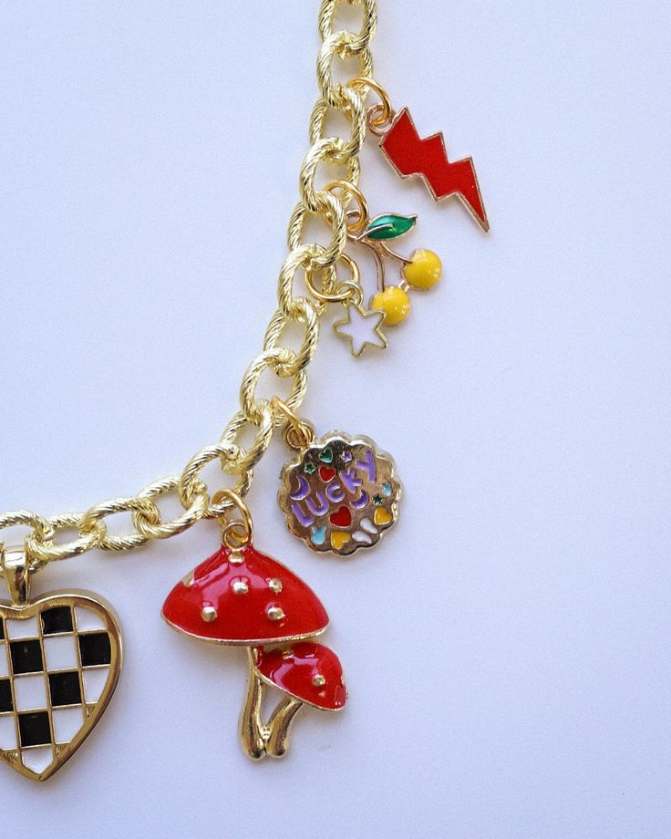 Add a splash of sunshine to your style with our Bright Summer-Themed Gold Plated Charm Necklace. This fun and vibrant accessory features an array of playful summer charms, perfect for capturing the season's essence. Measuring 17 inches in length, it's the ideal piece to brighten up any summer outfit. Crafted with high-quality gold plating, this necklace is designed to bring a touch of joy and color to your wardrobe. Playful Multicolor Jewelry With Removable Charms, Playful Charm Necklace With Dangling Charms For Gift, Playful Dangle Charms Necklace, Playful Dangle Necklaces With Charms, Playful Dangle Charm Necklace, Fun Multicolor Charm Jewelry, Trendy Multicolor Jewelry With Removable Charms, Trendy Dangle Charm Necklaces With Removable Charms, Trendy Festival Jewelry With Lobster Clasp