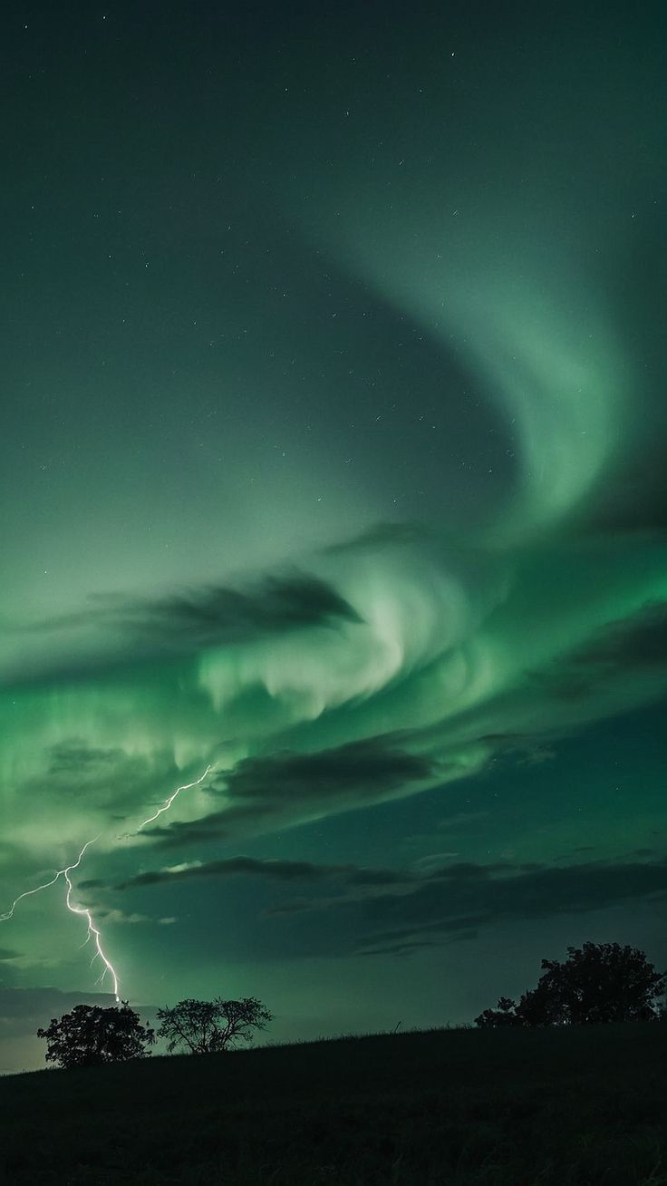 an image of a green and black sky with lightning