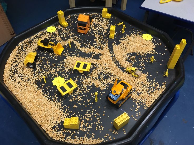 a play area with construction vehicles and sand