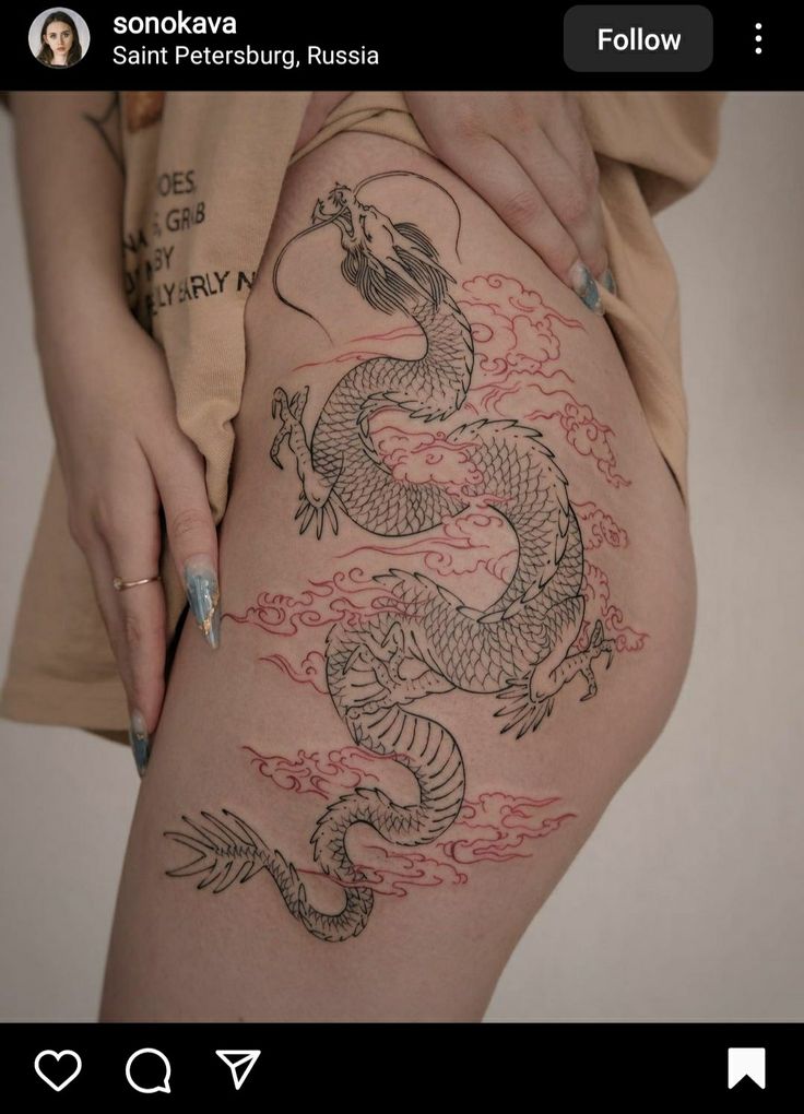 a woman's thigh with a dragon tattoo on it