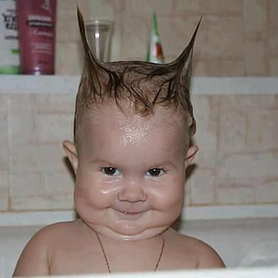 a baby with hair on top of it's head and the caption lol i am a batman