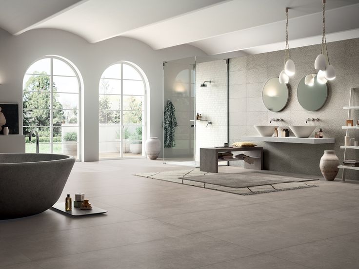 a large bathroom with two sinks and a bathtub in the middle of the room