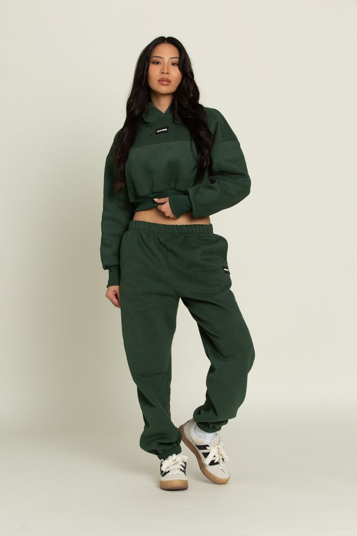 Elevate your athleisure style and feel like you're lounging on the go with our Hunter Green GH Jogger Sweatpants. The elastic waistband and tapered leg style allows you to feel secure and trendy. Complete with dual side pockets to keep your essentials close by. Pair with ur Hunter Green GH Cropped Hoodie to complete the set. Athleisure Style, Green Joggers, Tennis Skirts, Pocket Hoodie, Athleisure Fashion, Athletic Top, Yoga Tops, Jogger Sweatpants, Hunter Green