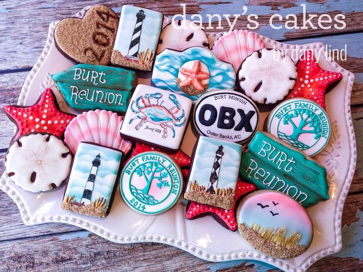 decorated cookies on a plate with words and seashells