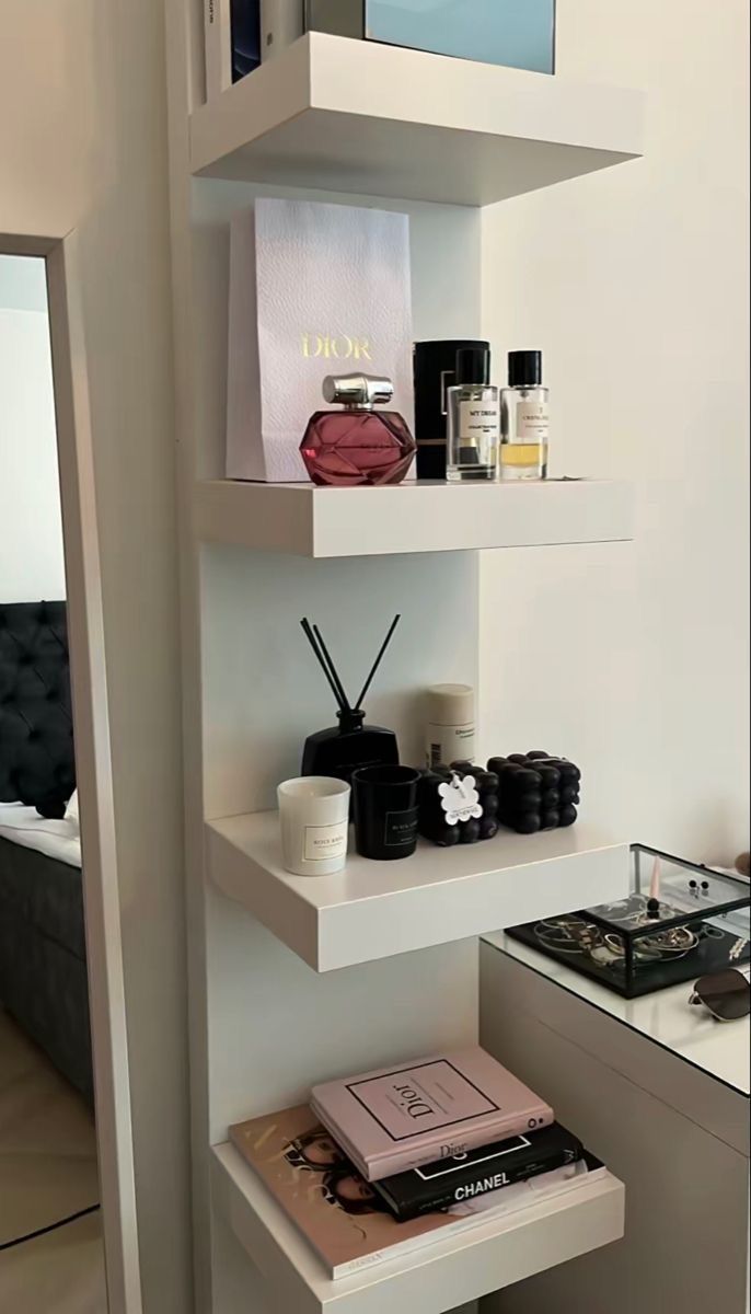 the shelves in this bathroom are filled with perfumes and personal care items, along with other essentials