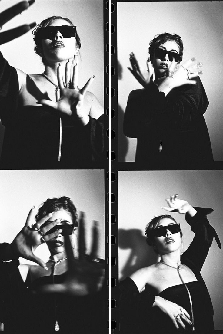 black and white photograph of woman in sunglasses making hand gestures