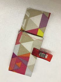 a colorful tie with a red tag on the bottom and a white background behind it