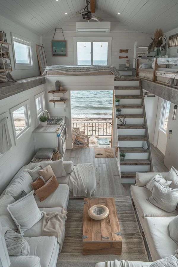 a living room filled with furniture next to a stair leading up to the top floor