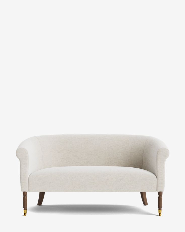 a white couch sitting on top of a wooden frame