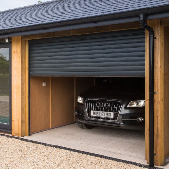 a car is parked in the garage with it's door open to allow access