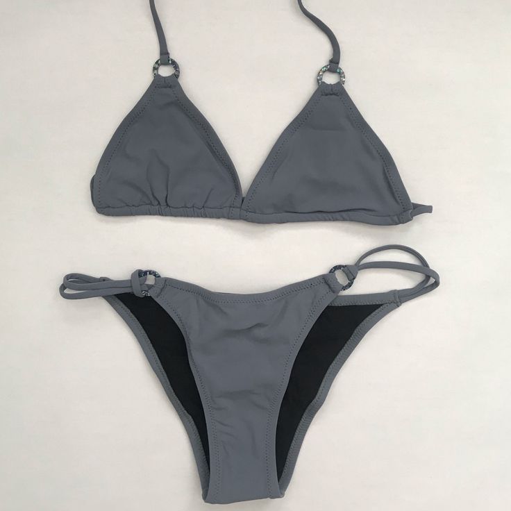 Tigerlily Brazil Triangle Top And Havana Bikini Bottoms With Ring Accents In Washed Graphite Color Size Listed: Us Sizing *Swimwear Items Are Nwt And Stored All Together In An Air Tight Sealed Container, Pulling Them Out May Result In Tag Pull Gray Swimwear For Pool And Beach Season, Gray Swimwear For Beach Season Vacation, Gray Swimwear For Vacation And Beach Season, Gray Beachwear Swimwear For Beach Season, Fitted Gray Swimwear For Vacation, Fitted Gray Swimwear For Summer, Fitted Gray Summer Swimwear, Gray Beachwear For Beach Season, Gray Beachwear Swimwear For Summer