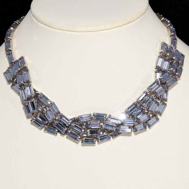 This is part of Chairish’s Costume Jewelry assortment.  Braided 1950s necklace decorated with alexandrite color changing rhinestones that appear light purple or blue depending on the light source. Metal is silver in color. Marked Weiss on tail of the hook closure. Measures 16" long and about 1" wide. Sparkling beauty on the neck. Silver Fine Jewelry Necklaces For Party, Silver Fine Jewelry Necklace For Party, Silver Jewels Evening Jewelry, Silver Jewelry With Jewels For Evening, Dazzling Silver Necklace For Evening, Elegant Evening Rhinestone Necklace, Silver Party Necklace With Stones, Silver Necklace With Stones For Party, Glamorous Evening Jewelry With Stones