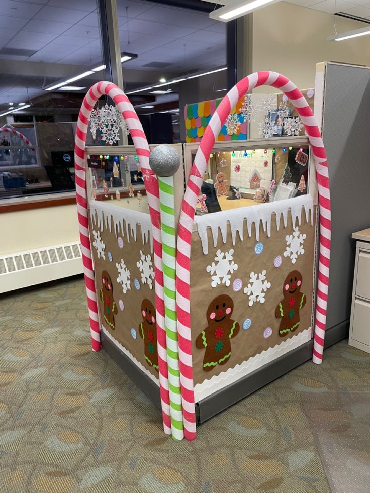 an office cubicle decorated for christmas with gingerbreads and candy canes on it