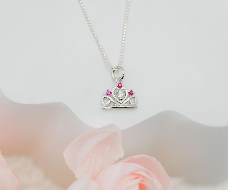 Fun and playful princess tiara charm necklace for toddlers and little girls.  This delightful tiara charm is accented with sparkling pink and clear CZs for that bling they love and comes with the option of adding a hand-made wire wrapped freshwater pearl charm ...the perfect gift for your little princess!  Great gift for princess birthday parties, party favor, or for that granddaughter that loves to sparkle! 🌸 This comes boxed in a beautiful gift box with care instructions ready for gifting. 🌸 Pink Princess Jewelry For Wedding, Princess Style Jewelry With Crown Design, Pink Charm Necklace For Birthday, Pink Charm Necklaces For Birthday, Pink Charm Necklace For Wedding, Pink Charm Necklaces For Wedding, Personalized Princess Style Jewelry For Gifts, Personalized Princess Style Jewelry Gift, Pink Crown-shaped Wedding Jewelry