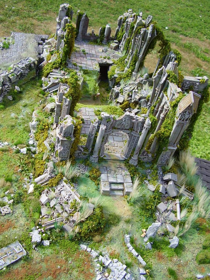 an aerial view of a ruined building with moss growing on it