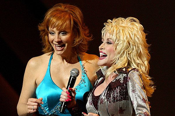 two women with microphones standing next to each other