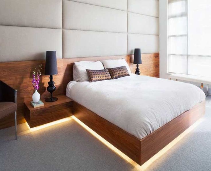 a large bed sitting in a bedroom next to two lamps on either side of it