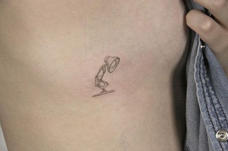 a person with a small tattoo on their stomach