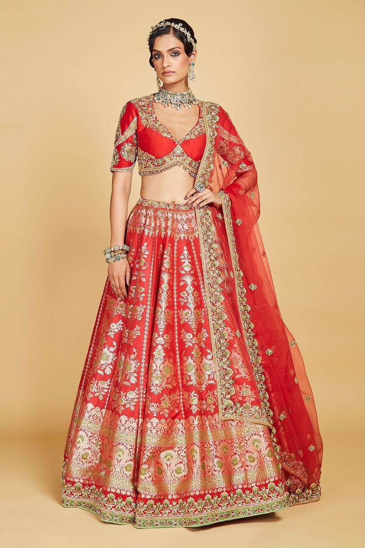 Crimson red lehenga crafted in banarasi silk base accentuated with contrast floral pattern in gold. Paired with V hem cutdana floral embellished and bow tie up blouse. Comes with cutdana and pearl embellished dupatta.
Component: 3
Pattern: Hand Embroidered 
Type Of Work: Zardosi, Pearl, Sequins
Neckline: Plunging V Neck
Sleeve Type: Half Sleeves
Fabric: Blouse and Lehenga: Pure Banarasi Silk, Dupatta: Organza Silk
Color: Red
Other Details: 
Padded blouse
Attached Can Can
Green cutdana embellishe Red Choli With Pallu For Diwali, Fitted Sharara For Puja, Red Bollywood Style Set With Pallu, Fitted Red Choli With Dupatta, Red Fitted Choli With Dupatta, Red Choli With Cutdana For Navratri, Red Embroidered Anarkali Set For Puja, Bollywood Red Choli With Pallu, Anarkali Choli With Tilla For Puja