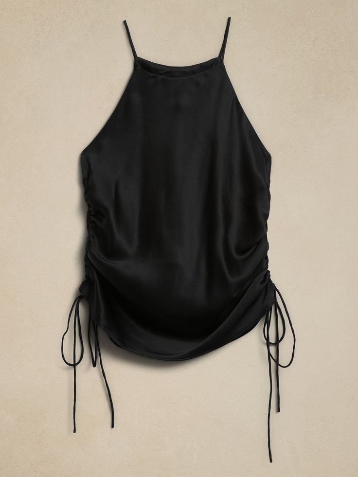 The return of an icon, this '90s inspired, ruched shirt will carry you through all occasions, crafted in a strappy silhouette using our luxuriously soft silk charmeuse, favored for its incredible drape and a subtle sheen.  Plus, our designers opted f Chic Ruched Silk Tops, Evening Satin Ruched Tops, Elegant Summer Tops With Ruched Back, Sleeveless Ruched Silk Top, Sleeveless Silk Ruched Top, Sleeveless Silk Top With Ruched Detail, Summer Evening Ruched Blouse, Summer Night Out Tops With Ruched Sides, Summer Ruched Sides Top For Night Out