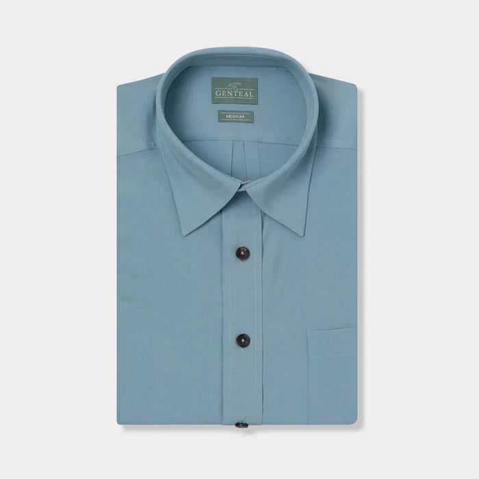 From GenTeal: "The vintage-styled Palmas Shirt is a short-sleeve button-up that is made to be worn untucked and by the water. Made with a unique blend of modal and polyester, it offers durability and comfort." 75% Modal, 25% Polyester Genuine horn buttons 8-button front Classic Light Blue Shirt With Pockets, Solid Color Short Sleeve Dress Shirt For Summer, Solid Color Short Sleeve Summer Dress Shirt, Formal Short Sleeve Tops With Pockets, Classic Solid Camp Shirt With Button Closure, Solid Color Short Sleeve Dress Shirt For Spring, Solid Short Sleeve Dress Shirt For Spring, Classic Solid Short Sleeve Shirt With Relaxed Fit, Classic Short Sleeve Dress Shirt For Spring