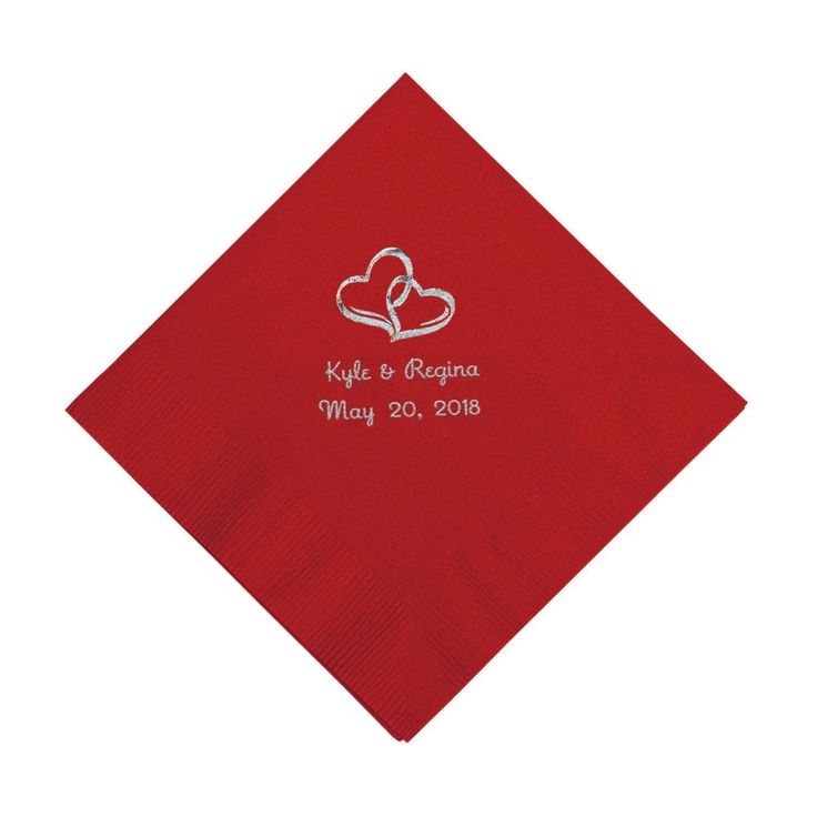 a red napkin with two hearts on it and the words, love is in the air