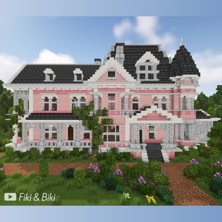 a large pink and white house with lots of windows