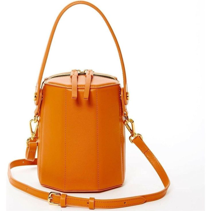 The Harper bag's octagonal silhouette lends a playful yet polished look to the orange leather exterior. Finished with gleaming gold hardware, this bucket bag is designed with an adjustable handle that enables it to effortlessly transition from handheld to slung over the shoulder. Its top zipper will keep your contents secure inside, while the cotton lined interior with 3 compartments keeps everything organized. This trendy designer crossover barrel bucket purse comes with a long and adjustable l Convertible Backpack Purse, African Accessories, Bucket Purse, Bucket Handbags, Mini Bucket Bags, Mini Bucket, Bag Dark, Dark Orange, Leather Bucket Bag