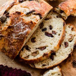 sliced loaf of bread with raisins on top