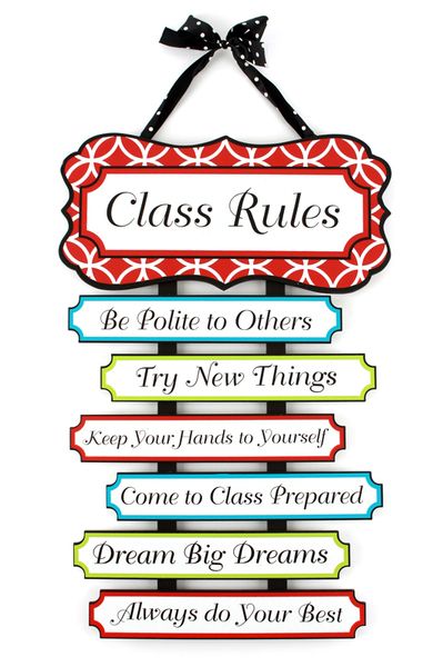 a sign hanging from the side of a wall that says class rules be polite to others try new things keep your hands to yourself come