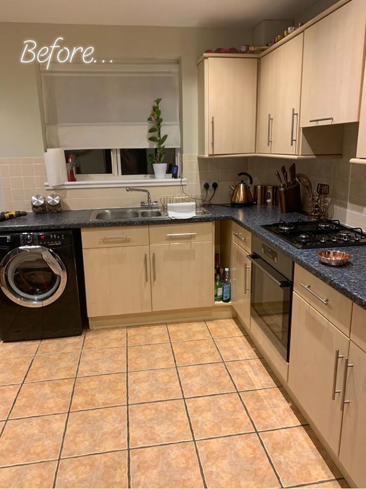 a kitchen with tile flooring and wooden cabinets next to a washer and dryer