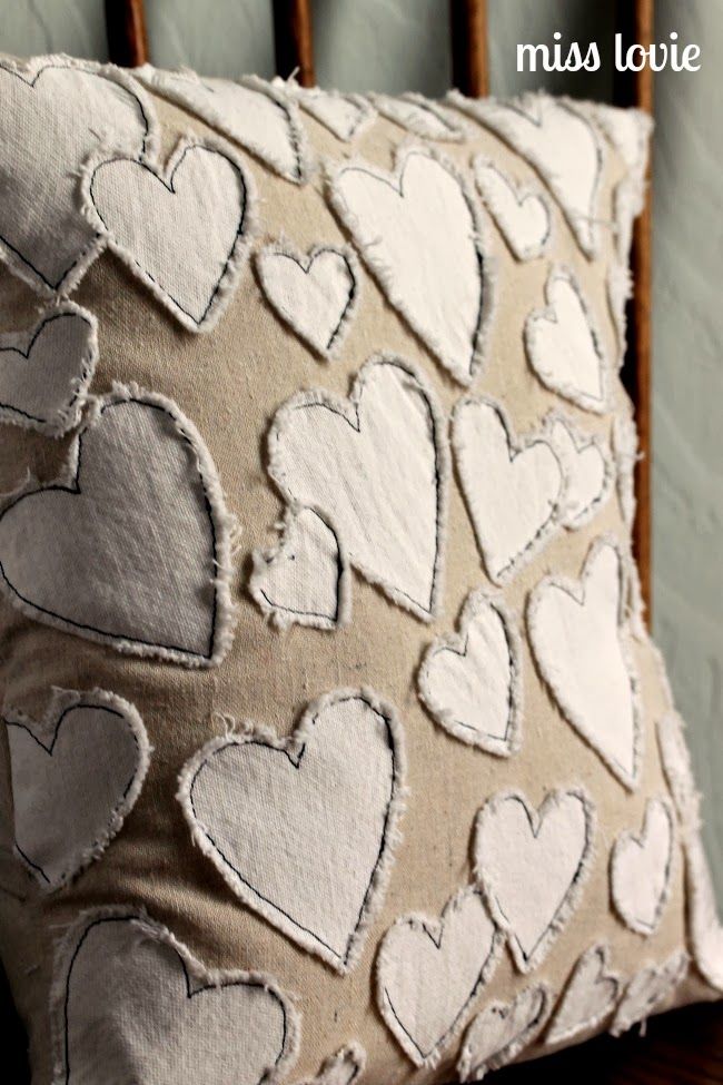 a close up of a pillow on a wooden chair with hearts drawn on the back