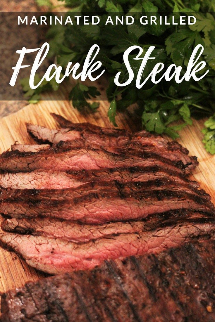 sliced steak on a cutting board with parsley in the background and text overlay reads marinated and grilled flak steak