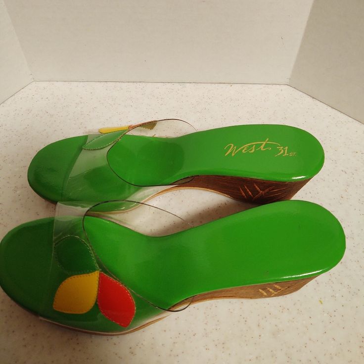 Look At The Detail On These Beautiful Sandals. Green, Orange, Yellow Petals On Clear. Looks Brand New. Details On Sides And Backs Of Heel. Yellow Fun Slip-on Sandals, Green Round Toe Summer Sandals, Casual Green Open Toe Heels, Retro Open Toe Sandals For Vacation, Green Slip-on Wedge Sandals For Vacation, Green Slip-on Wedge Sandals For Beach, Green Jelly Sandals With Round Toe For Summer, Summer Green Wedge Heel Sandals, Green Wedge Heel Sandals For Summer