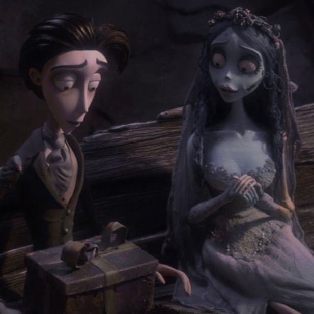 the corpse bride and groom are sitting next to each other in front of an old chest