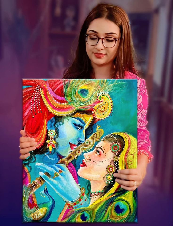 a woman holding up a colorful painting with peacocks on it's face and two women in the background