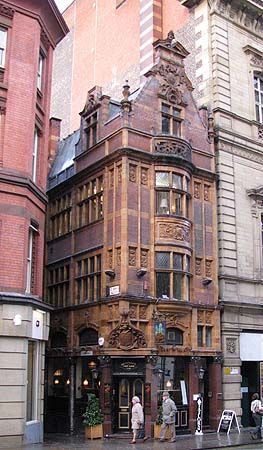 an old building is on the corner of a street