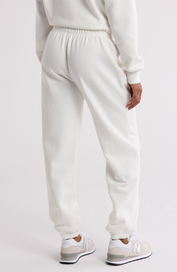 For everyday errands and warm weekends, these classic fleece sweatpants will keep you cozy. Elastic waistband On-seam pockets 68% cotton, 32% recycled polyester Machine wash, tumble dry Imported Fleece Bottoms With Elastic Cuffs For Loungewear, Basic Bottoms With Ribbed Cuffs, Fleece Bottoms With Elastic Waistband For Loungewear, White Sporty Bottoms For Everyday, Casual Cream Sweatpants For Lounging, Cream Casual Sweatpants For Lounging, Fleece Bottoms With Comfort Waistband For Loungewear, Comfort Waistband Fleece Bottoms For Loungewear, White Cotton Bottoms With Ribbed Waistband