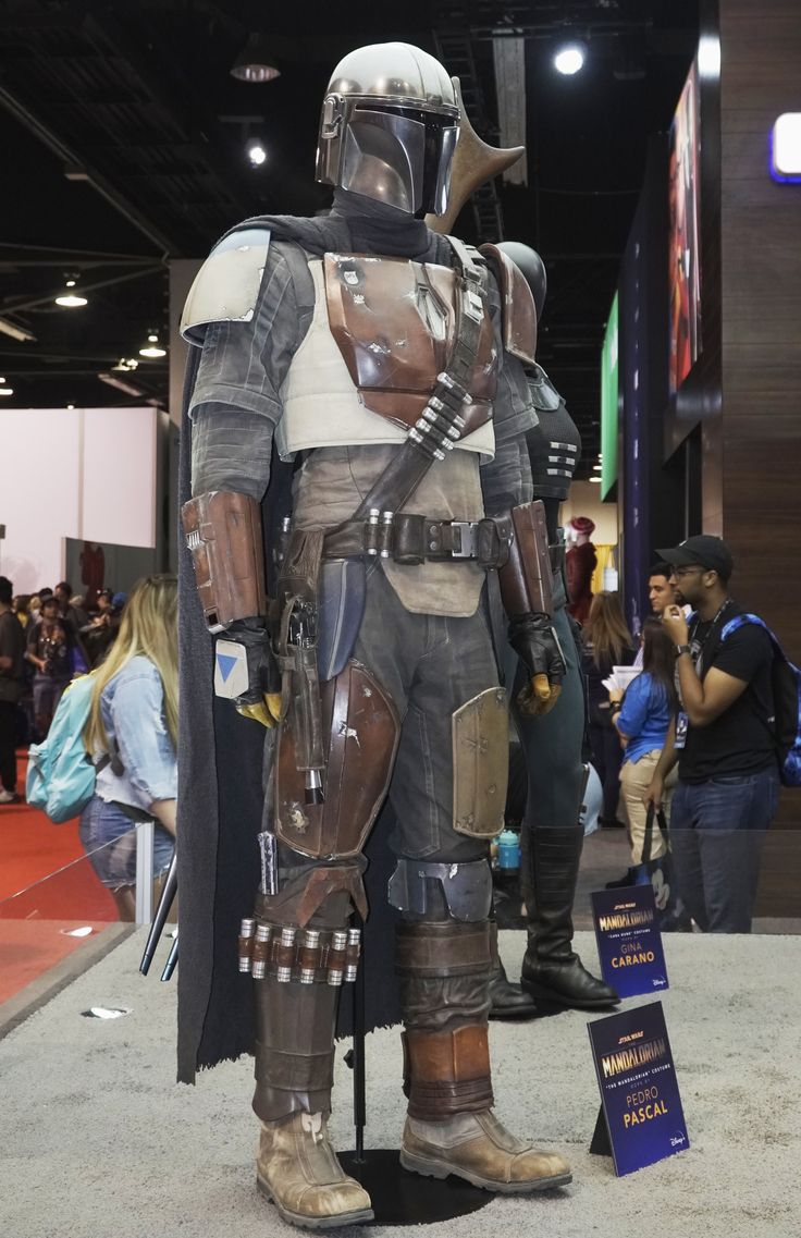 a man dressed up as boba fett from star wars standing in front of a crowd