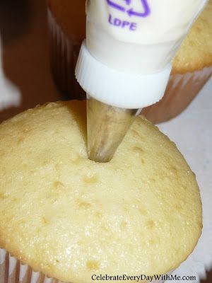 a cupcake being frosted with icing by someone