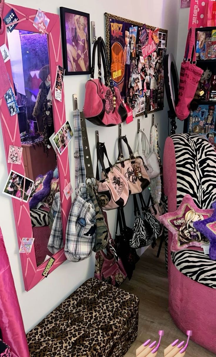 a room filled with lots of pink and zebra print furniture next to a wall covered in pictures