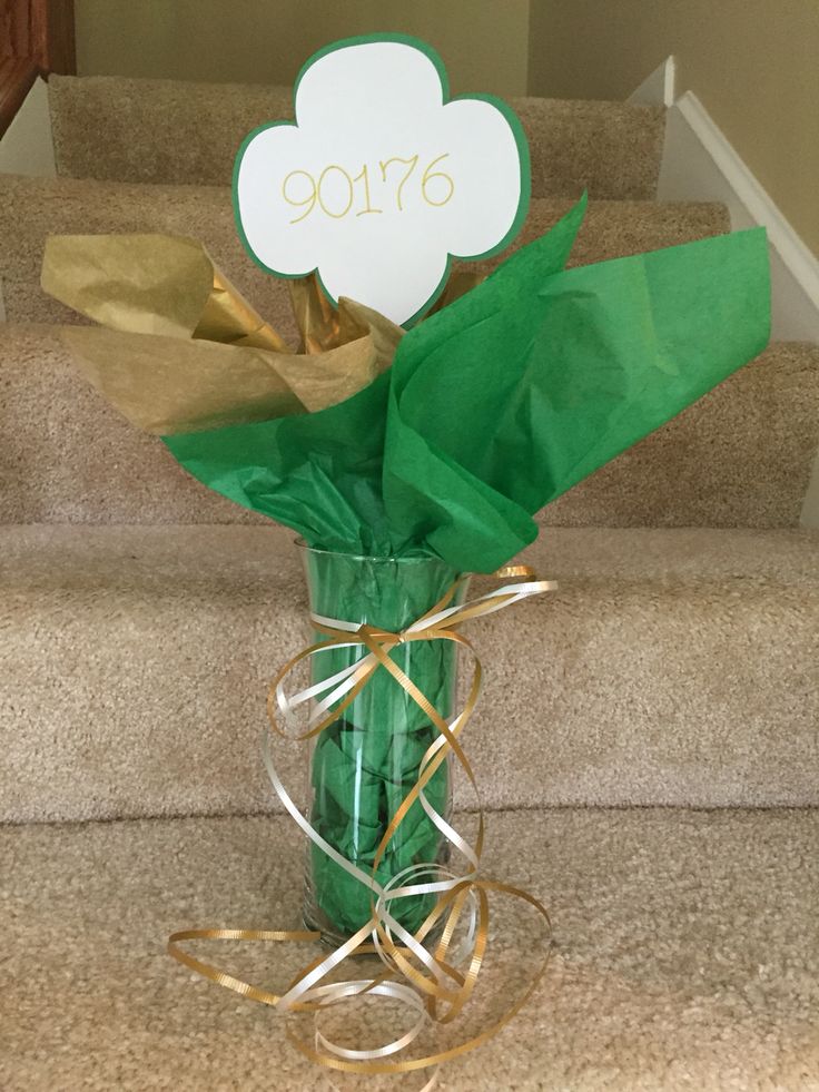 a vase filled with flowers sitting on top of a carpeted stair case next to a hand rail