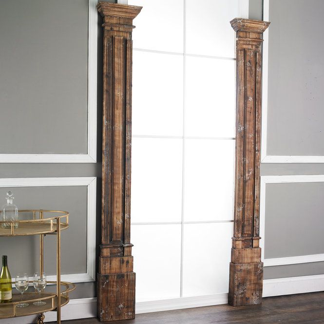 two tall wooden pillars in an empty room