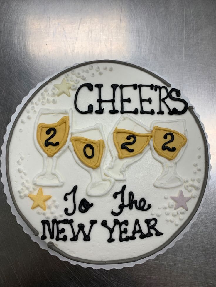 a cake with three glasses on it that says cheers 2012 to the new year