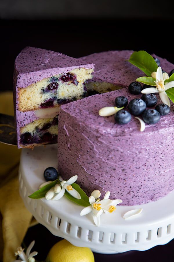 a cake with blueberries and lemons on it