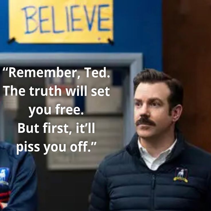 two men standing next to each other in front of a blue wall with a quote on it